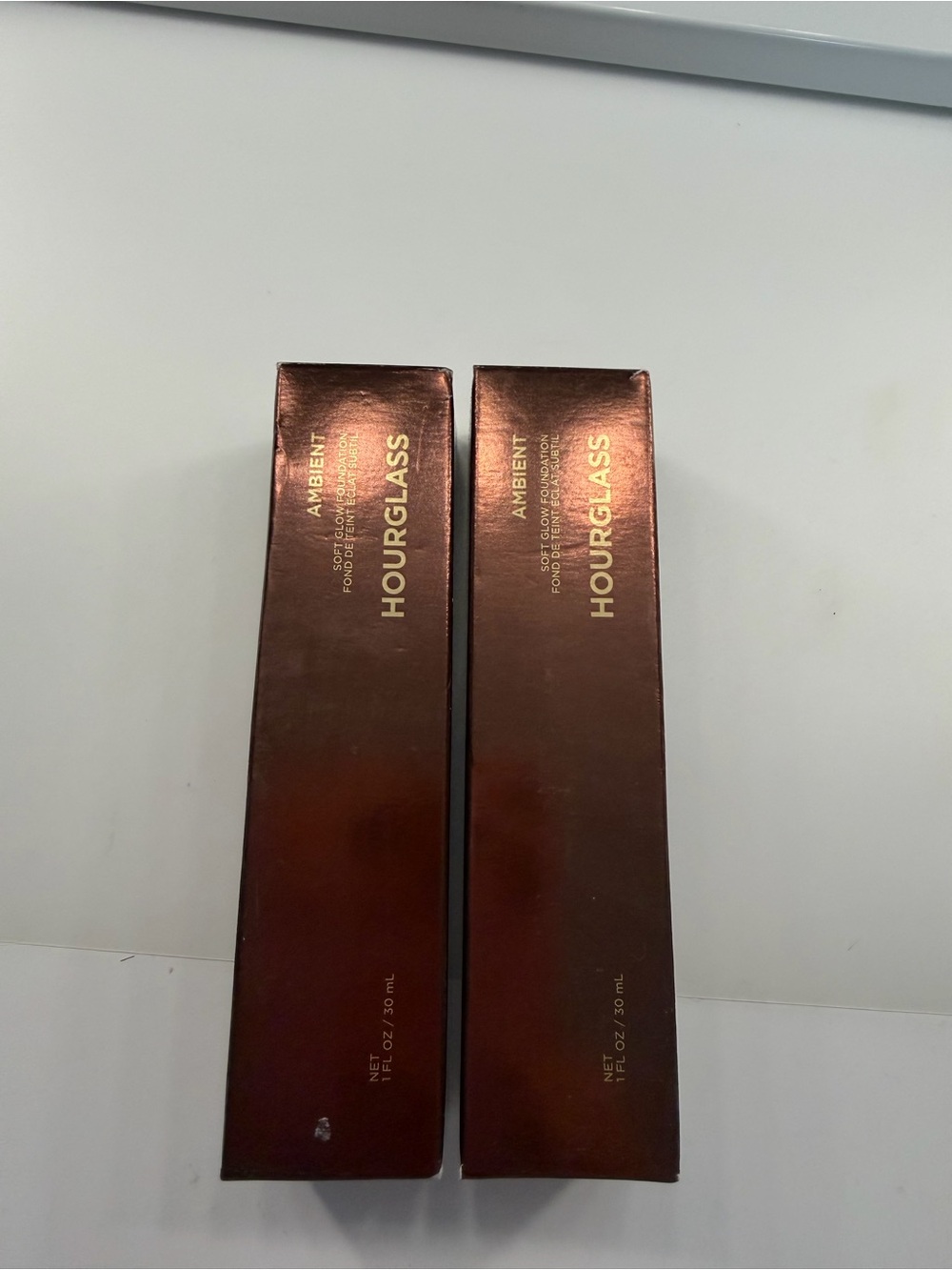 Hourglass Ambient Soft Glow Foundation in Frosted Beige and Dark Bronze Pump